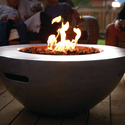 Fire pit with flames on a wooden deck, people sitting around